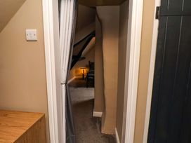A hallway with a chair and light at G's Loft in Whitby