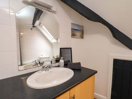 A bathroom with a sink and mirror at G's Loft in Whitby
