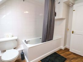 A bathroom with a bathtub and toilet at G's Loft in Whitby