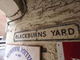 A sign that reads BLACKBURN'S YARD at G's Loft in Whitby