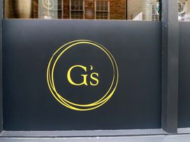 A sign with the logo of G's at G's Loft in Whitby