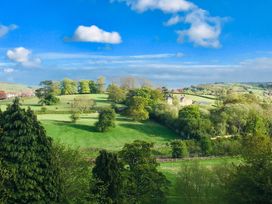 A landscape with trees and horses in a field at Groves Hall Garden Apartment Whitby