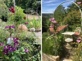 A garden with flowers and a seating area at Groves Hall Garden Apartment Whitby