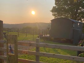 An outdoor photo with a shepherd's hut and sunset at The Peacock Shepherds Hut at Hafoty Boeth Corwen
