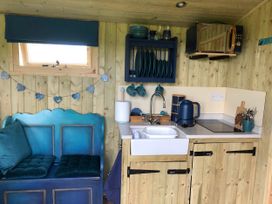 A kitchen with a sink and kettle at The Peacock Shepherds Hut at Hafoty Boeth, Corwen