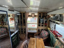 A living room with furniture and storage in the 2 x Double Bed Glamping Wagon at Dalby Forest, Scarborough