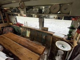 A kitchen with a wooden table and various items on the shelf at 2 x Double Bed Glamping Wagon at Dalby Forest, Scarborough