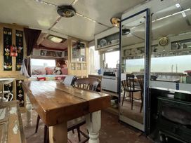 A dining area with a table and chairs at 2 x Double Bed Glamping Wagon at Dalby Forest Scarborough