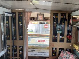 A glamping wagon interior with a bed and window at 2 x Double Bed Glamping Wagon at Dalby Forest Scarborough