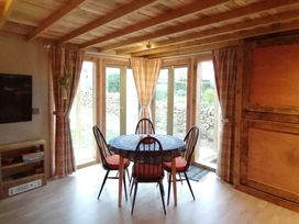 A dining room with a table and chairs at Stone Moor Lodge, Justin's Peak District Base Camp, Sheffield