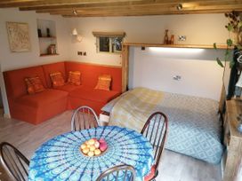 A living room with a sofa and a dining table at Stone Moor Lodge, Justin's Peak District Base Camp in Sheffield