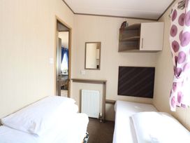 A bedroom with beds and a mirror at PK Sunset View in Corton