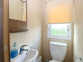 A bathroom with a sink and toilet at PK Sunset View in Corton