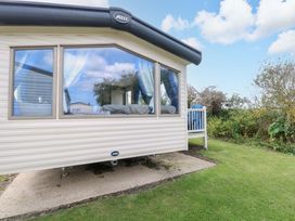 A static caravan with a deck and steps at PK Sunset View in Corton