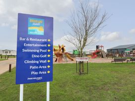 An outdoor area with playground and facilities at Broadland Sands Holiday Park in Corton