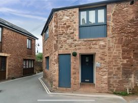 A corner of a stone building with a door and windows at Seaside Cottage Escape in Paignton