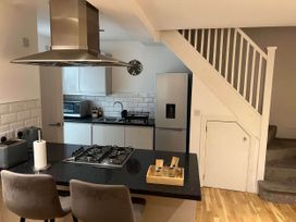 A kitchen with a stove and refrigerator at Seaside Cottage Escape in Paignton