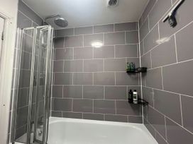 A bathroom with a shower and bathtub at Seaside Cottage Escape in Paignton