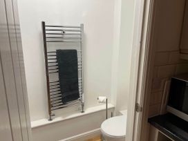 A bathroom featuring a towel rail and toilet at Seaside Cottage Escape in Paignton