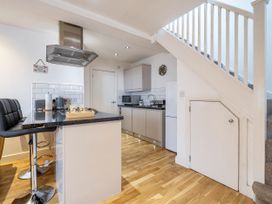 A kitchen with a stove and refrigerator at Seaside Cottage Escape in Paignton