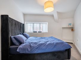 A bedroom with a bed and window at Seaside Cottage Escape in Paignton