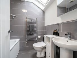 A bathroom with a bath tub, sink, and toilet at Seaside Cottage Escape in Paignton