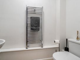 A bathroom with a towel warmer and toilet at Seaside Cottage Escape in Paignton