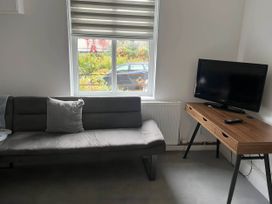 A living room with a sofa and television at Llangollen - House - Sleeps 8- Garden in Llangollen