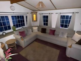 A living room with a sofa and coffee table at Llanarmon-yn-Ial Mold 3-Bed Caravan, Sleeps 6 Llanarmon-Yn-Ial