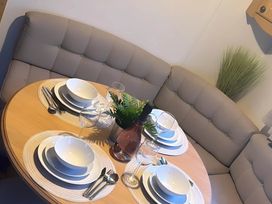 A dining table set with plates and glasses at Llanarmon-yn-Ial Mold 3-Bed Caravan, Sleeps 6 Llanarmon-Yn-Ial