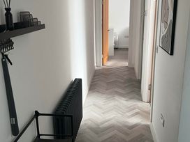 A hallway with a radiator and doors at Modern Seaside Cottage - Sleeps 5 Paignton