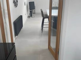 A dining room with a TV and a dining table at Modern Seaside Cottage - Sleeps 5, Paignton