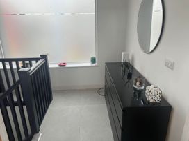 A hallway with a mirror and a dresser at Modern Seaside Cottage - Sleeps 5 Paignton