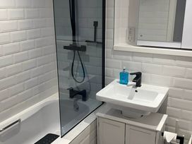 A bathroom featuring a bathtub, shower, and sink at Modern Seaside Cottage - Sleeps 5 in Paignton