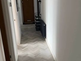 A hallway with a door and a coat rack at Modern Seaside Cottage - Sleeps 5, Paignton