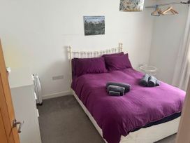 A bedroom with a bed and towels arranged on it at Modern Seaside Cottage - Sleeps 5 in Paignton