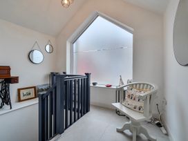 A landing with mirrors and a chair at Modern Seaside Cottage - Sleeps 5 in Paignton