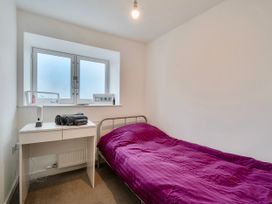 A bedroom with a bed and desk at Modern Seaside Cottage - Sleeps 5 in Paignton