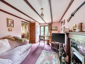 A living room with a couch and television at Converted Stone Barn -20 Acres - Farm Animals! in Corwen