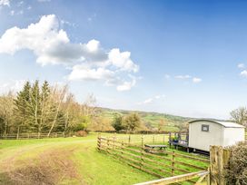 An outdoor area with a shed and fencing at Converted Stone Barn -20 Acres - Farm Animals! in Corwen