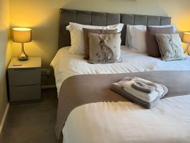 A bedroom with a bed and bedside lamp at 2 Bed House - Sleeps 4 - Garden - Parking - Wifi, Kendal