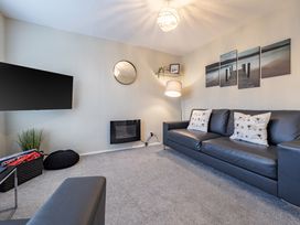 A living room with a sofa and television at 2 Bed House - Sleeps 4 - Garden - Parking - Wifi, Kendal