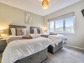 A bedroom with two beds and window at 2 Bed House - Sleeps 4 - Garden - Parking - Wifi Kendal