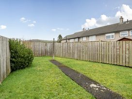 A garden with grass and a pathway at 2 Bed House - Sleeps 4 - Garden - Parking - Wifi, Kendal