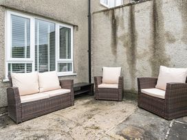 A patio with outdoor seating consisting of a sofa and chairs at 2 Bed House - Sleeps 4 - Garden - Parking - Wifi, Kendal