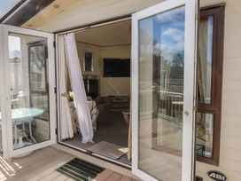 A living room with a sofa and television at CaravanSleeps6-FreeParking-QuietRetreat-Nature in Paignton