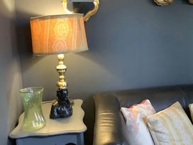 A living room with a lamp and a vase on a table at Dobbin the horse box in The Lake District Cockermouth