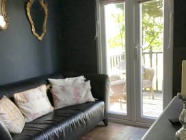 A living room with a sofa and cushions at Dobbin the horse box in The Lake District