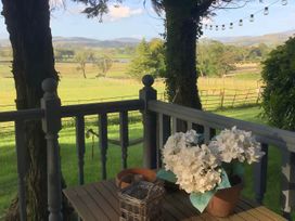 An outdoor area with a table and flower pot at Dobbin the horse box in The Lake District Cockermouth