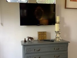 A living room with a television mounted on the wall at Dobbin the horse box in The Lake District Cockermouth